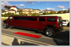 Red Carpet Hummer Limousine Service waiting for clients to arrive for this birthday party limo ride in Perth and Fremantle. Black tyres, chrome grille and Candy Red in Colour.